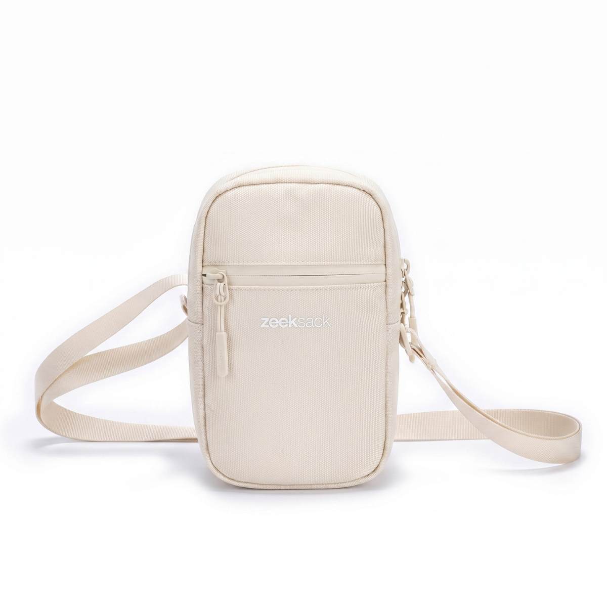 Zeeksack Travel Pouch (hiekanbeige) – olkahihna ja vetoketjullinen etutasku.