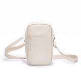 Zeeksack Travel Pouch (hiekanbeige) – olkahihna ja vetoketjullinen etutasku.
